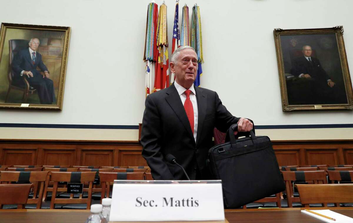 Defense Secretary Jim Mattis sets his briefcase down before he testifies at a House Armed Services Committee hearing on the defense budget for the 2018 budget year, on Capitol Hill, Monday, June 12, 2017, in Washington. (AP Photo/Alex Brandon)