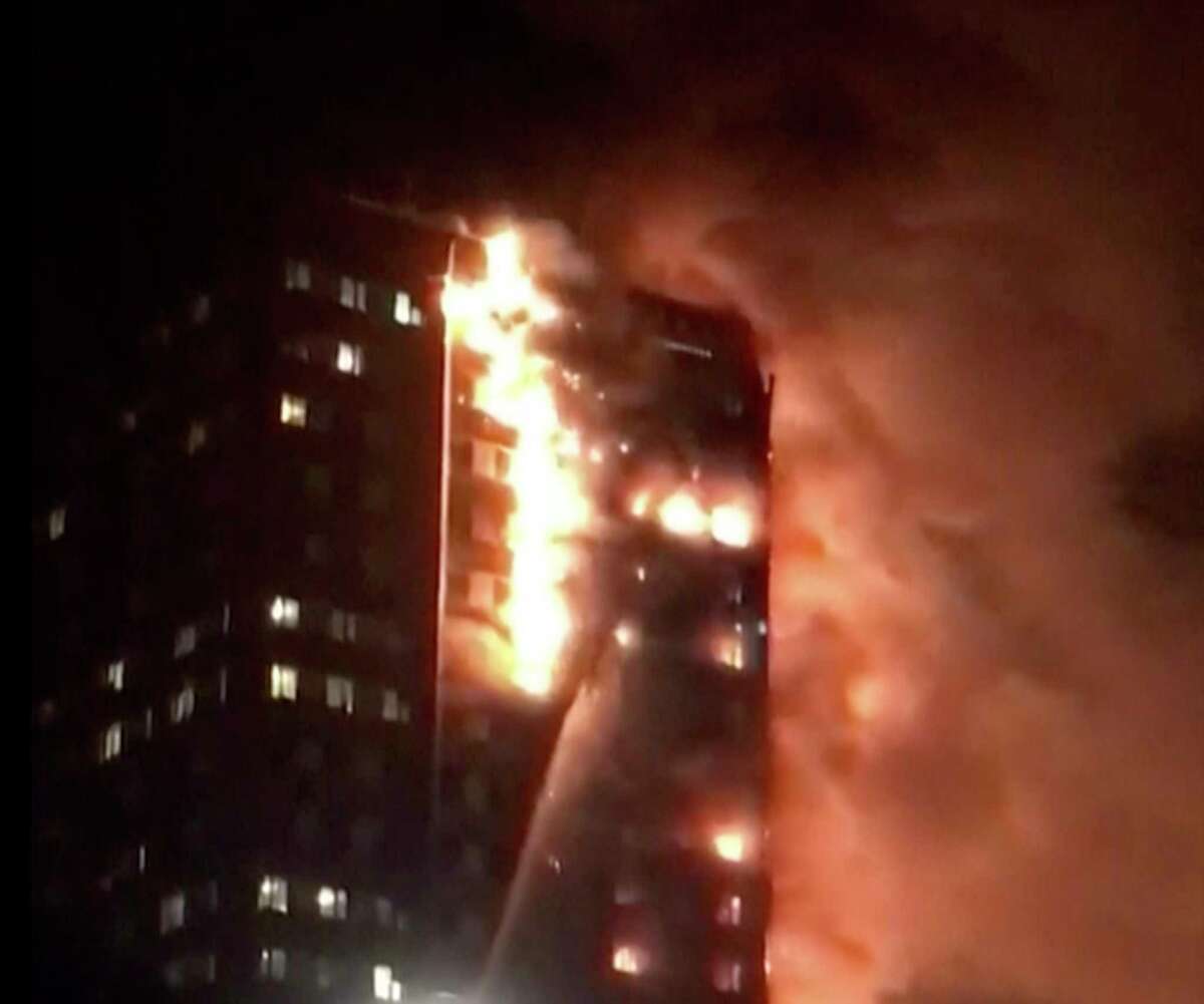 In this image made from video provided by Celeste Thomas @MAMAPIE, a building is on fire in London, Wednesday, June 14, 2017. Firefighters are battling a massive fire in an apartment high-rise in London. One side of the building appeared to be in flames. (Celeste Thomas @MAMAPIE via AP)