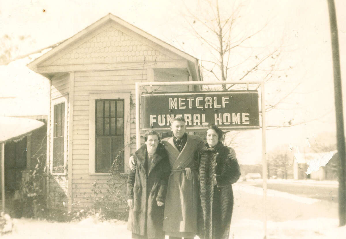 From left, Naomi Metcalf, Leo Thomas Metcalf Sr. and Metcalf's sister in front of the Metcalf Funeral Home in 1938. This location was in a home on Davis Street in Conroe before the streets were paved and before Davis connected to Frazier Street.
