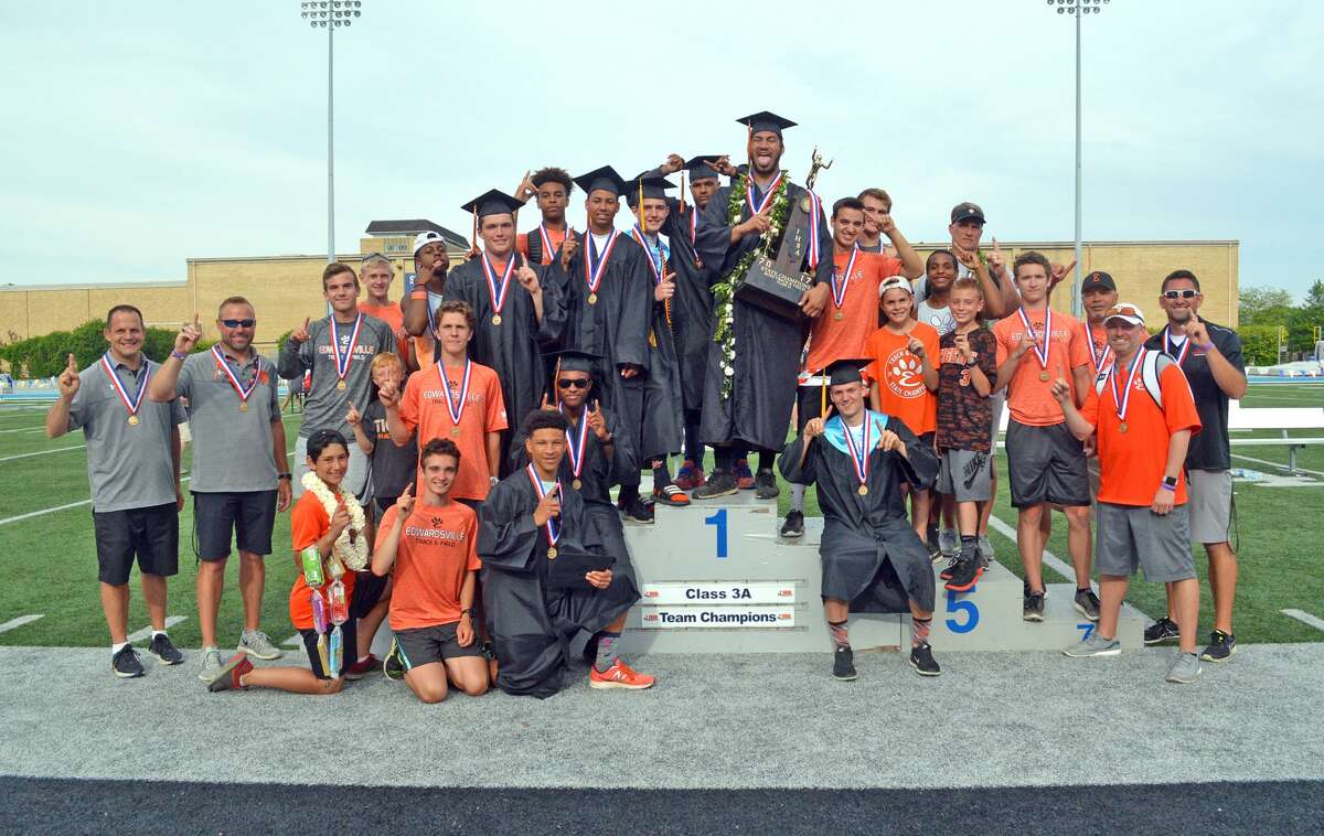 With the seniors wearing caps and gowns for graduation, the Edwardsville boys’ track and field team celebrates its first-place finish in the Class 3A state meet on May 27 in Charleston.