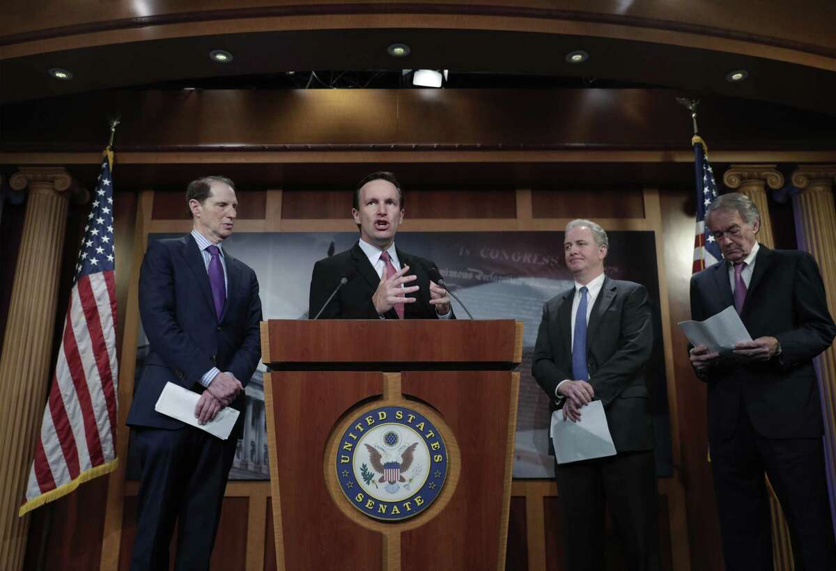 U.S. Sen. Chris Murphy, D-Conn., center, criticizes the tax breaks in the GOP-authored American Health Care Act, on Capitol Hill in Washington June 6.