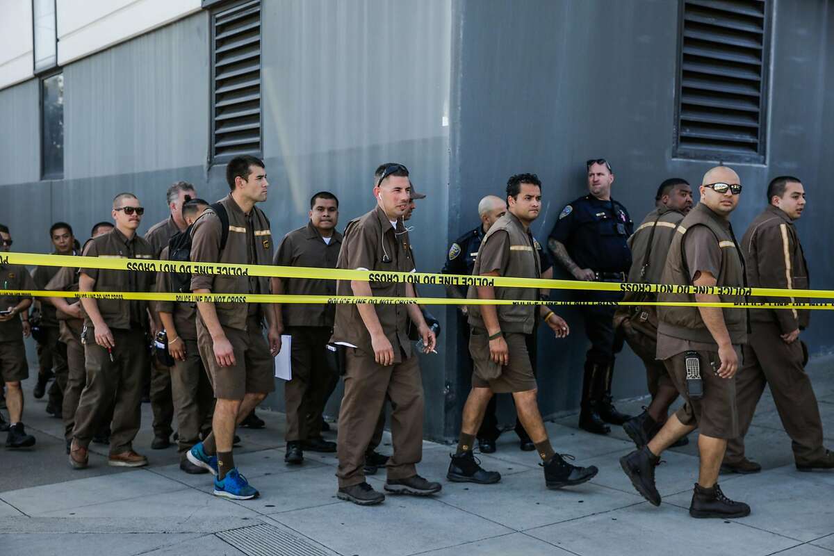 UPS workers evacuate their building at the scene of an active shooting at 16th Street and Utah Street in San Francisco, California, on Wednesday, June 14, 2017.