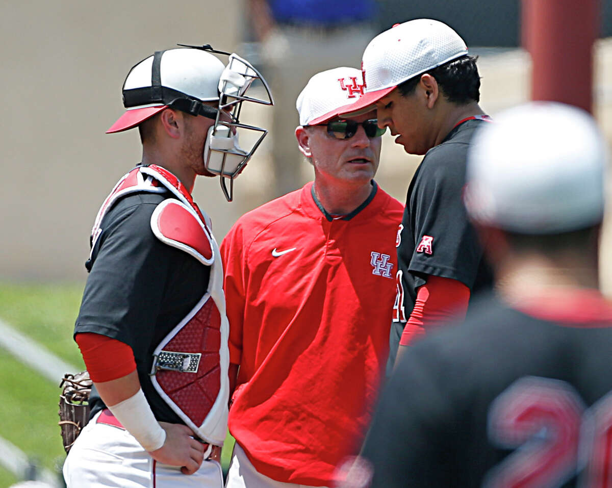 Houston assistant coach Frank Anderson center, speaks with Houston pitcher Seth Romero right, Houston catcher Jacob Campbell left, looks on during the second inning of Men's College baseball game action at Schroeder Park Friday, May 20, 2016, in Houston. ( James Nielsen / Houston Chronicle )