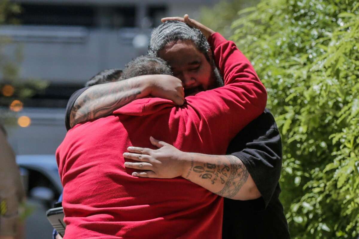 People embrace at San Francisco General Hospital following an active shooting in Potrero Hill in San Francisco on Wednesday, June 14, 2017. The people are said to be related to a victim of the shooting.