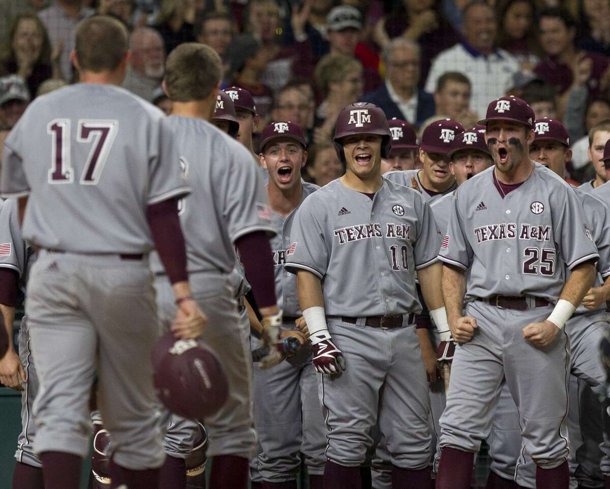 Texas A&M players celebrate after a three-run homer by Walker Pennington off TCU starting pitcher Nick Lodolo during the first inning of a Houston College Classic baseball game at Minute Maid Park Saturday, March 4, 2017, in Houston.