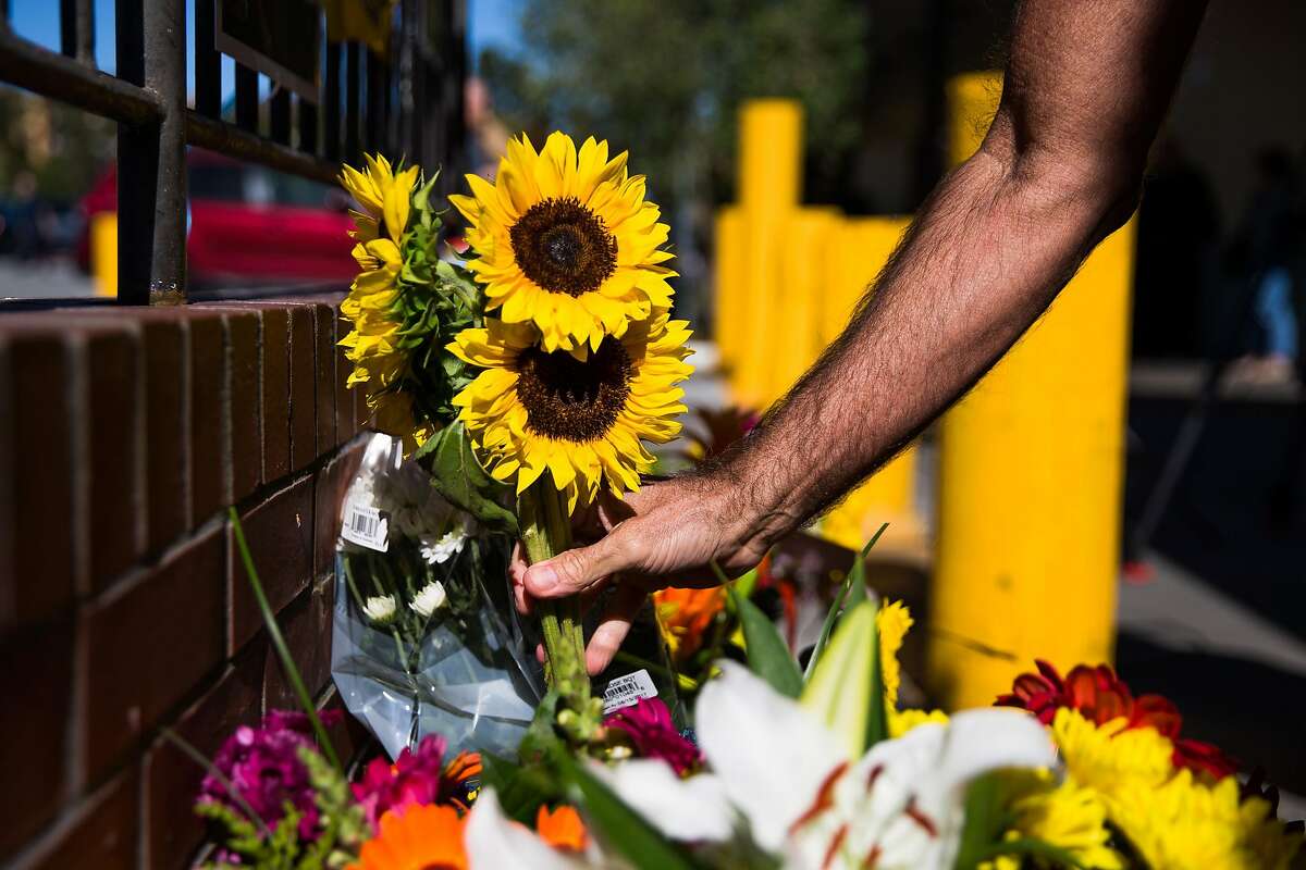 Flowers at the memorial set up in front of Creighton's Bakery & Cafe for victims of the UPS shooting in San Francisco.