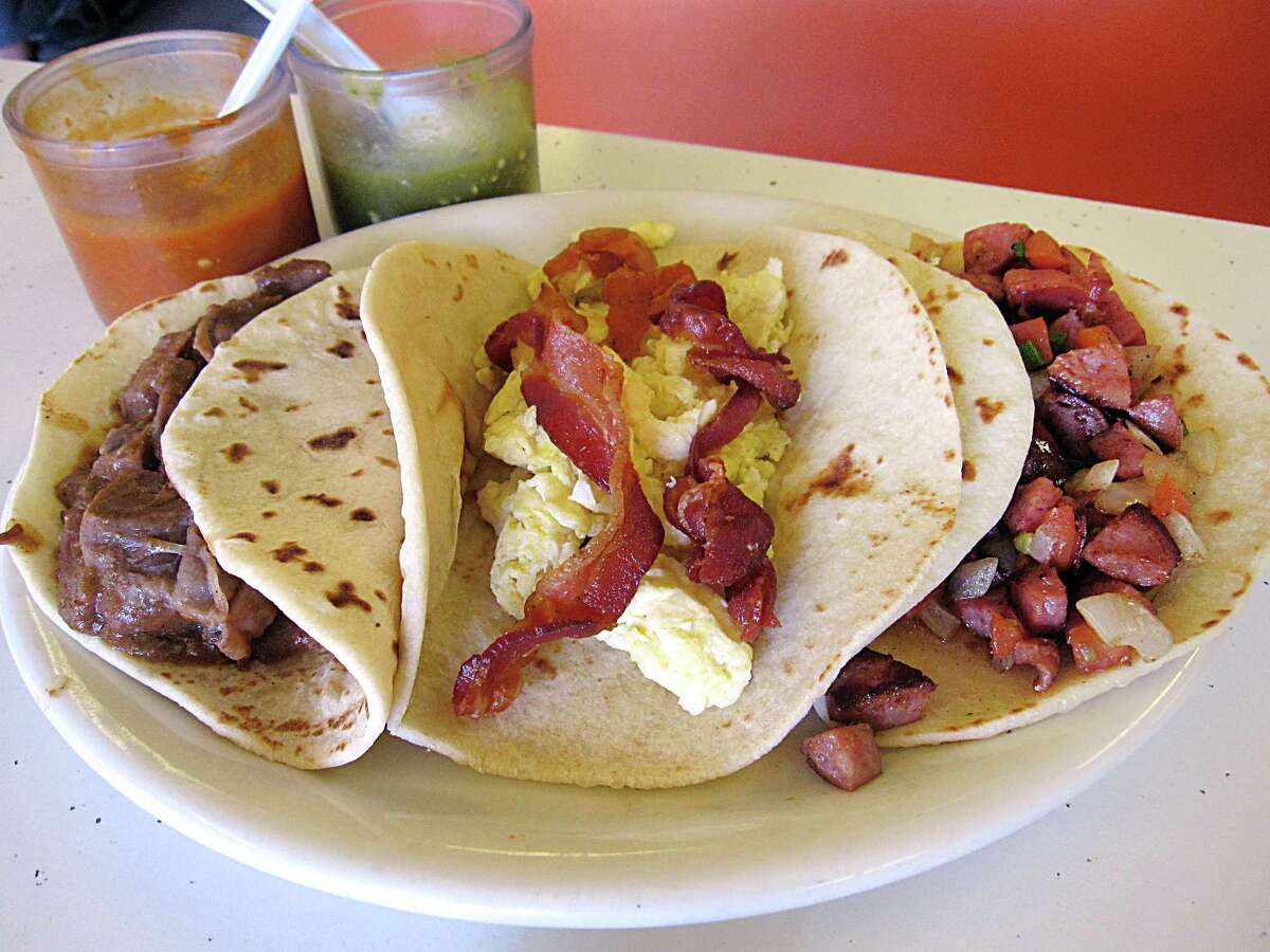 Carne guisada, left, bacon and egg and country a la mexicana tacos, all on handmade flour tortillas, from Brothers Taco House.