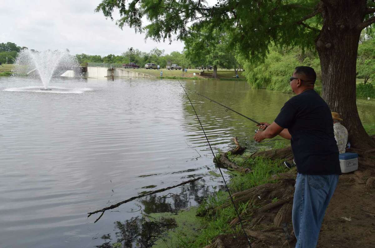 Frank Rodriguez gets his catfish-catching gear ready for a Texas Parks & Wildlife Department stocking of more than 1,000 channel cats at the lake at Southside Lions Park as part of the Neighborhood Fishin’ program.