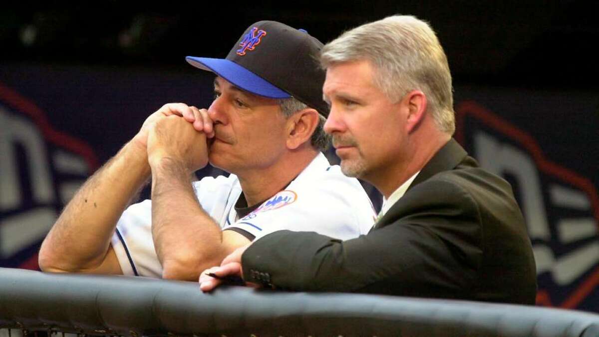 2001: Mets' manager Bobby Valentine and General Manager Steve Phillips watch the team warm up before the game.