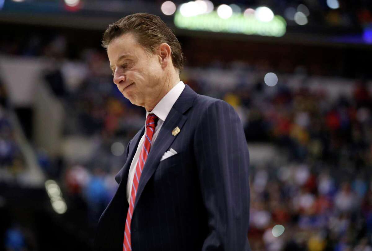 FILE - In this March 19, 2017, file photo, Louisville head coach Rick Pitino walks off the court after a 73-69 loss to Michigan in a second-round game in the men's NCAA college basketball tournament in Indianapolis. Louisville and coach Pitino are awaiting discipline from the NCAA on Thursday, June 15, 2017, regarding a sex scandal that engulfed the men's basketball program. A former men's basketball staffer is alleged to have hired strippers to entertain players and recruits. (AP Photo/Jeff Roberson, File)