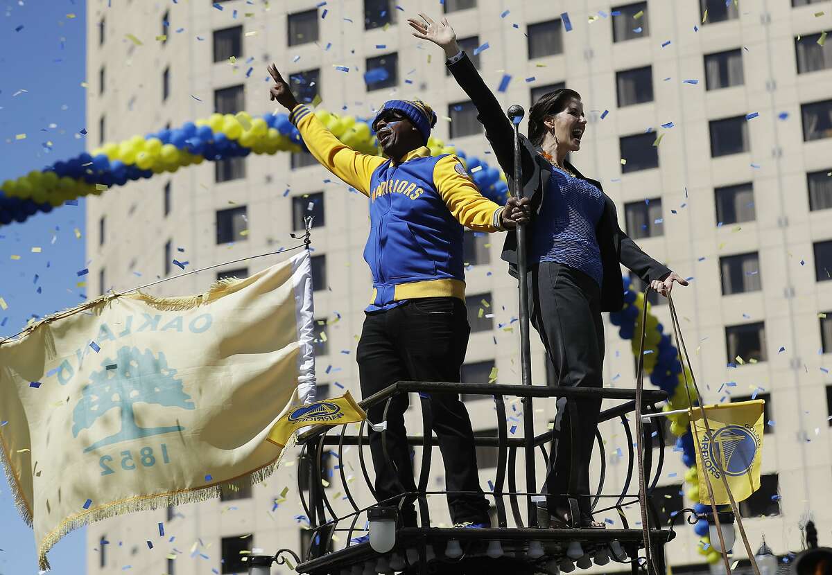 Oakland Mayor Libby Schaaf, right, and MC Hammer wave at fans during a parade and rally in honor of the Golden State Warriors, Thursday, June 15, 2017, in Oakland, Calif., to celebrate the team's NBA basketball championship. (AP Photo/Marcio Jose Sanchez)