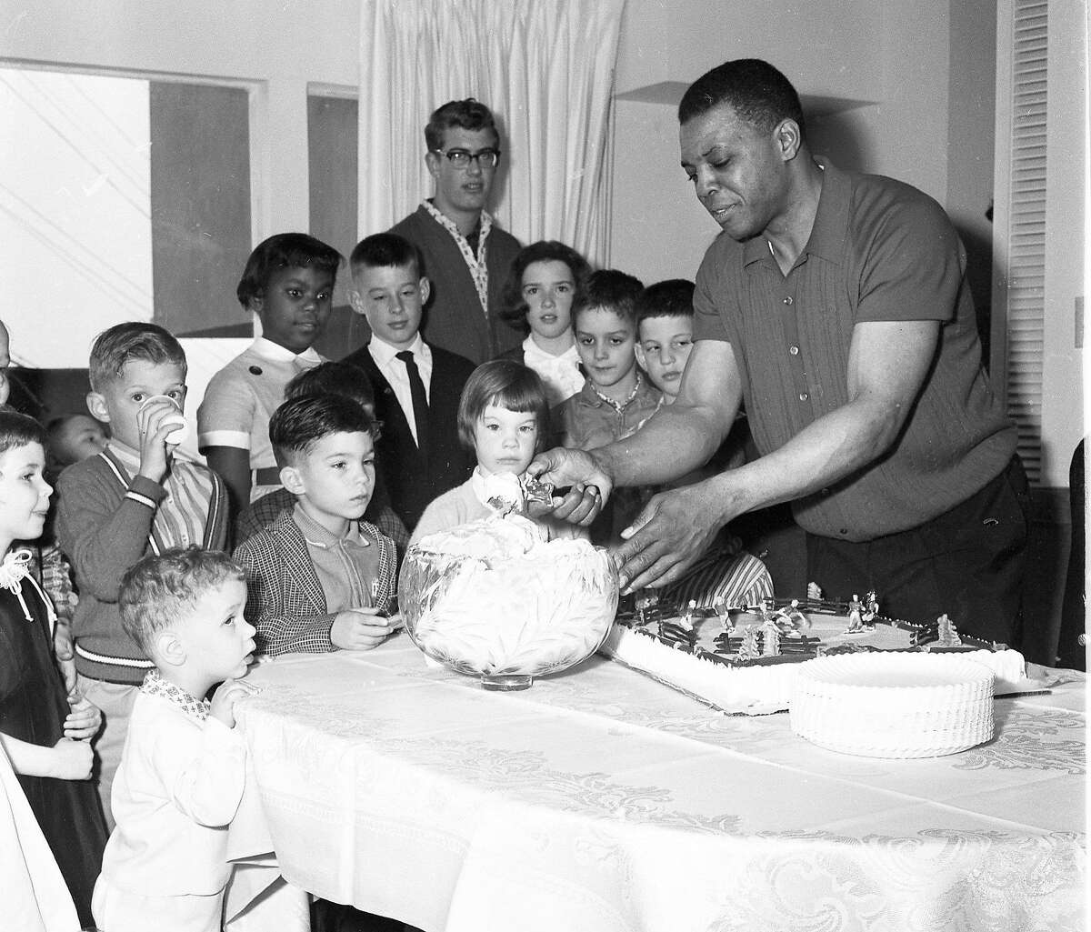 Feb. 16. 1963: Willie Mays serves ice cream during a party at the San Francisco Giants player's San Francisco home.
