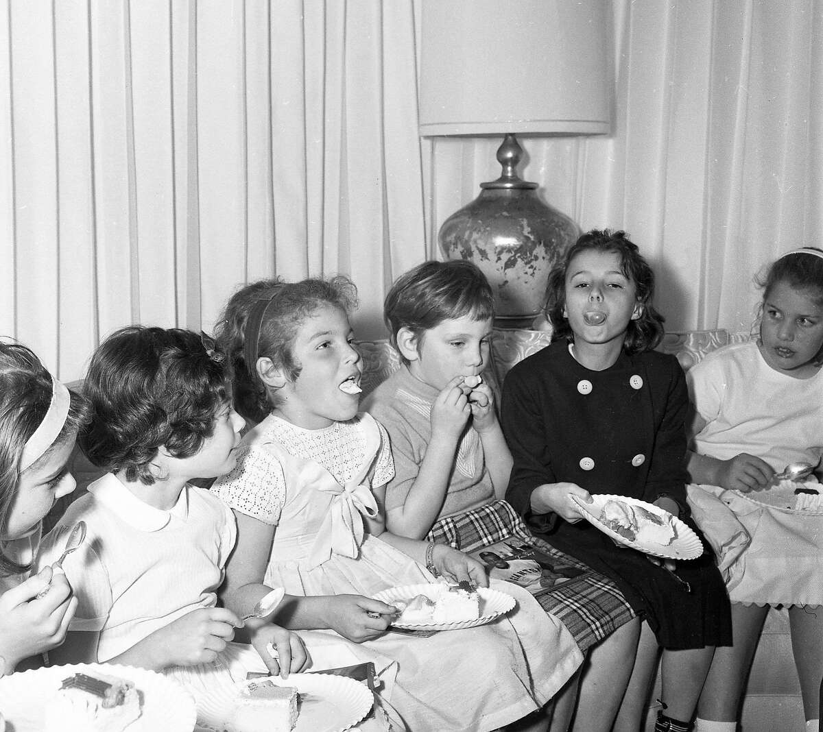 Children eat cake and ice cream during a party at Willie Mays' house in San Francisco on Feb. 16, 1963. The Giants players invited his neighbors.