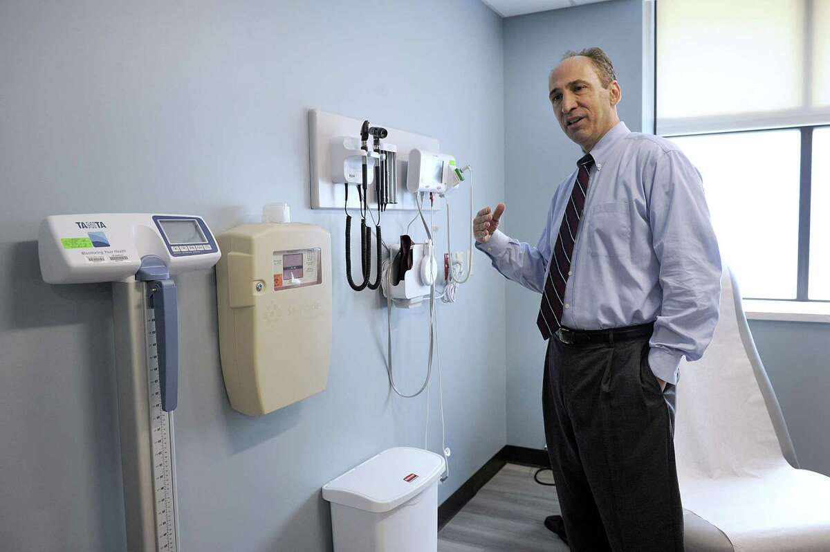 Dr. Thomas Koobatian, chief of staff and executive director at New Milford Hospital, explains the amenities in an examination room in the new primary care facility at the hospital, Thursday, June 15, 2017.