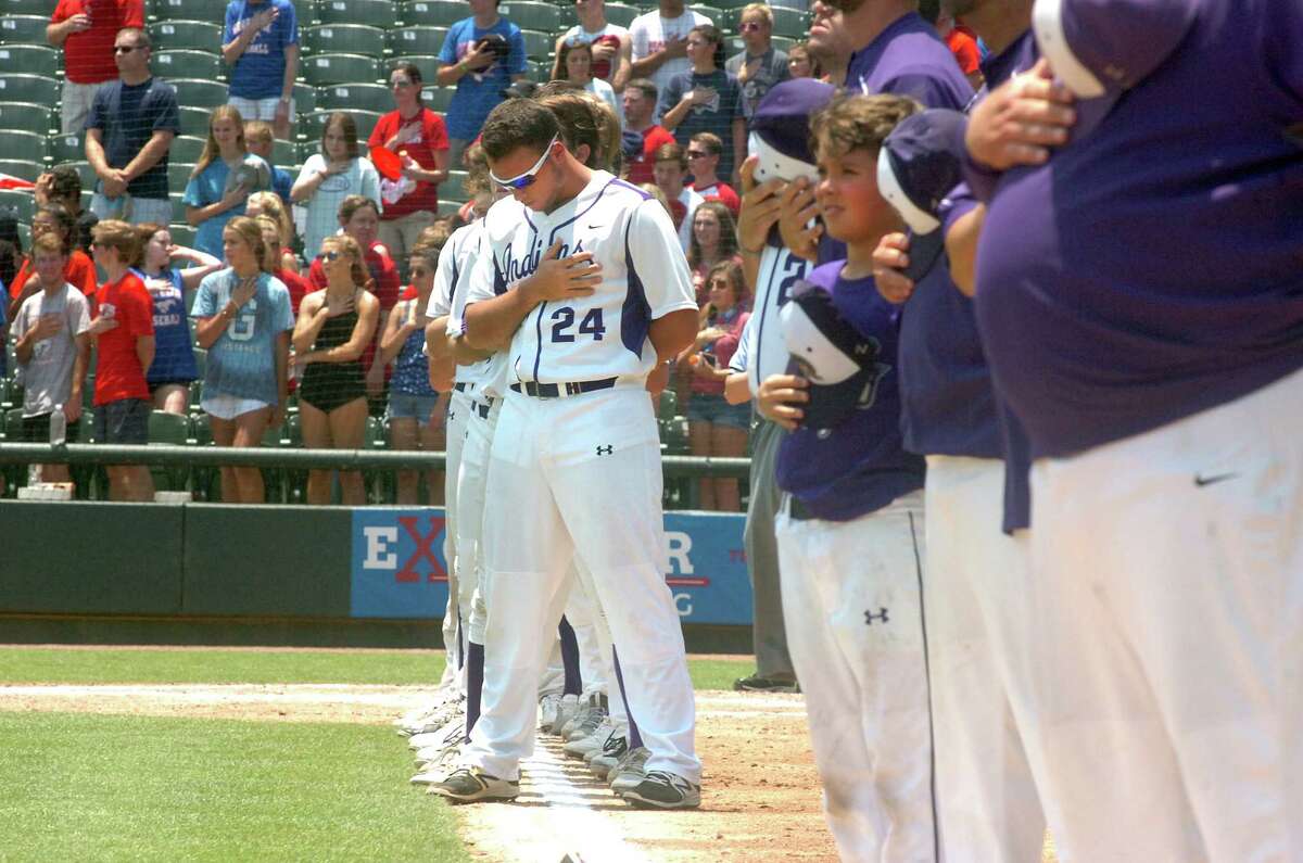 Senior Holden Lane places his hand over his heart, along with the rest of the Port Neches-Groves baseball team, as the National Anthem is played before the start of the Class 5A state baseball final with Grapevine on Saturday, June 10 at Dell Diamond in Round Rock. (Mike Tobias/The Enterprise)