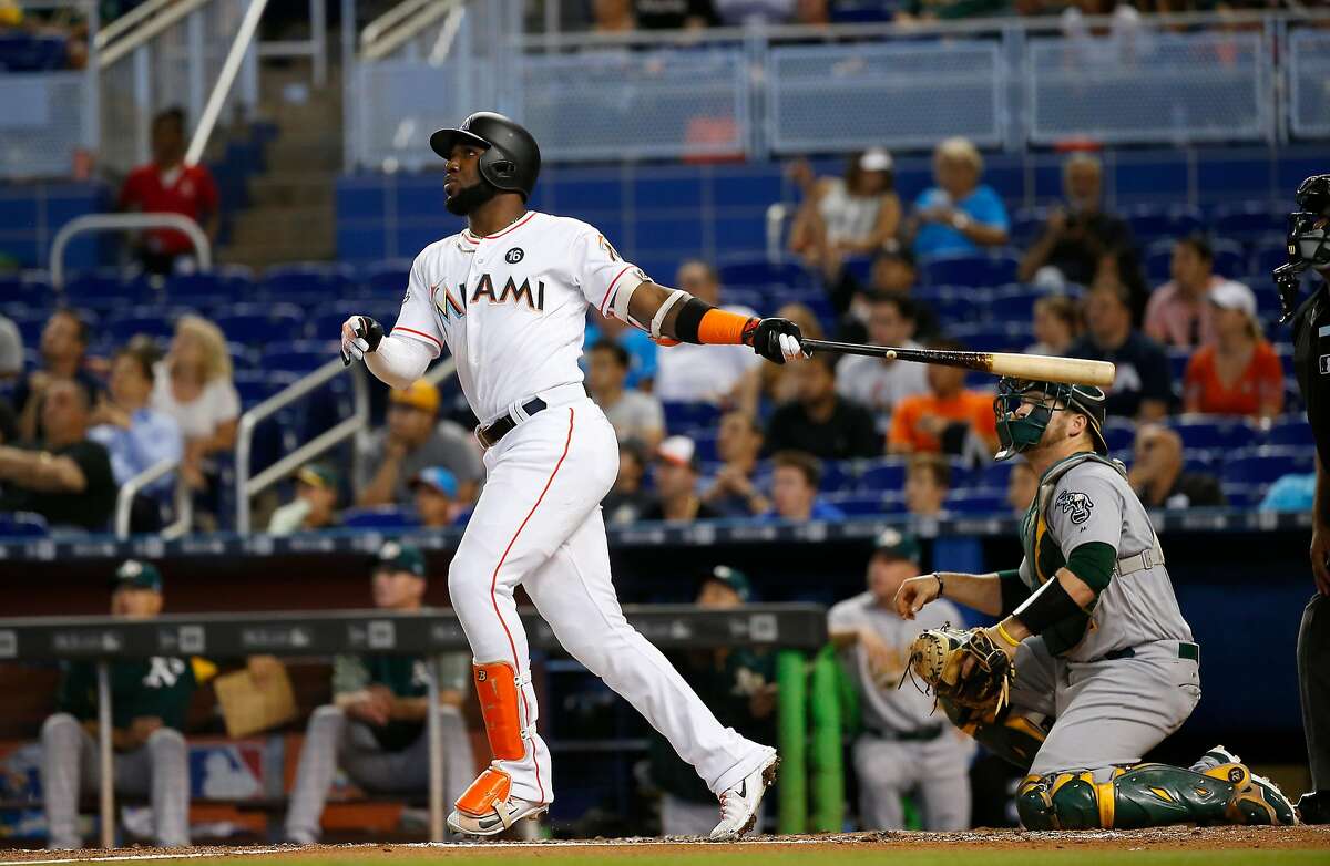 The Miami Marlins' Marcell Ozuna hits a solo home run during the second inning against the Oakland Athletics at Marlins Park on Wednesday, June 14, 2017, in Miami. The Marlins won, 11-6. (David Santiago/El Nuevo Herald/TNS)