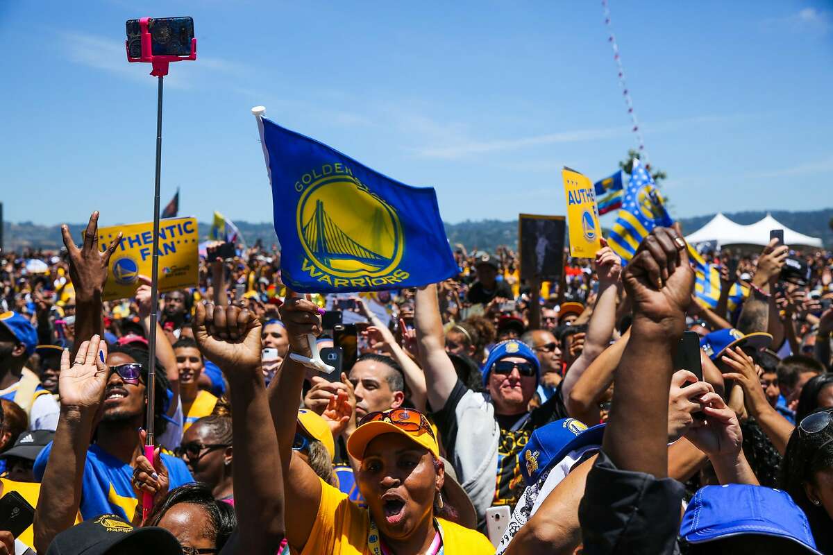 Golden State Warriors' fans cheer during a rally following the Golden State Warriors championship parade in Oakland, Calif., on Thursday, June 15, 2017.