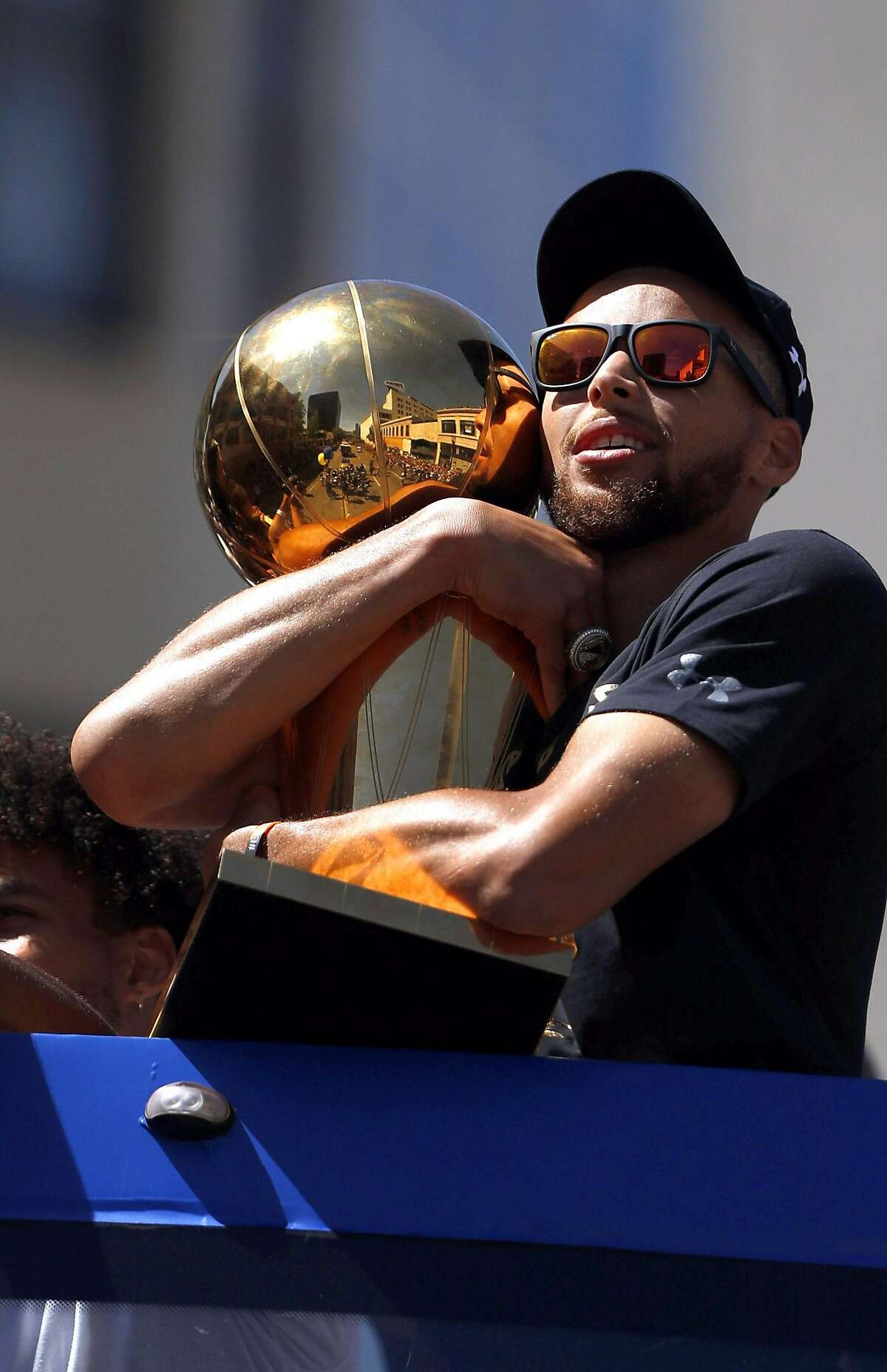 Stephen Curry holds the Larry O'Brien Trophy as the Golden State Warriors celebrated their NBA Championship with a victory parade in Oakland, Calif., on Thursday, June 15, 2017.