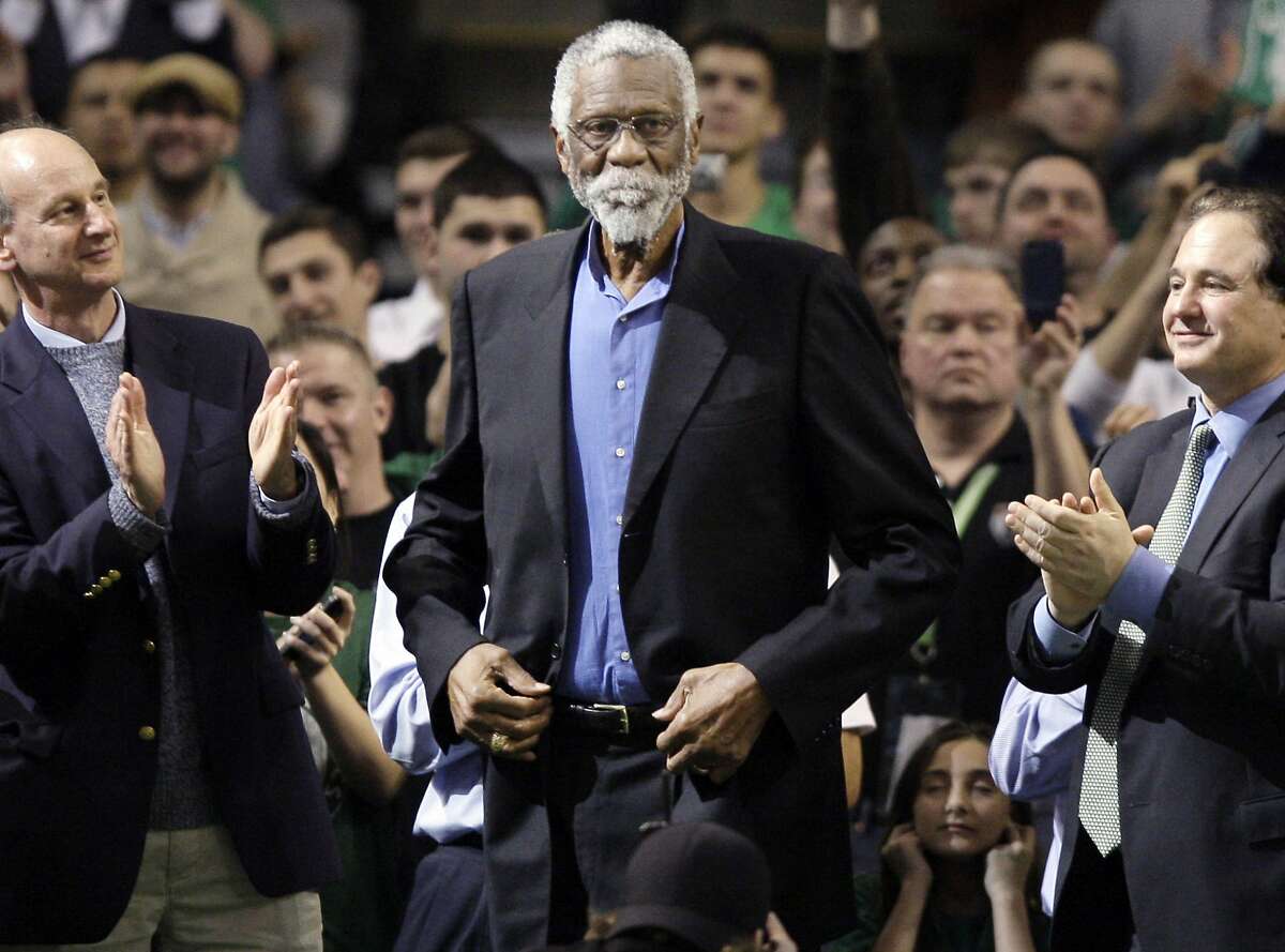 FILE - In this Feb. 15, 2012, file photo, former Boston Celtic Bill Russell, center, receives a standing ovation after being introduced prior to the Celtics' NBA basketball game against the Detroit Pistons in Boston. Russell will be honored with the "Lifetime Achievement Award" during the first NBA Awards, it was announced Thursday, June 15, 2017. The awards show will be June 26 in New York and be televised by TNT. (AP Photo/Elise Amendola, File(