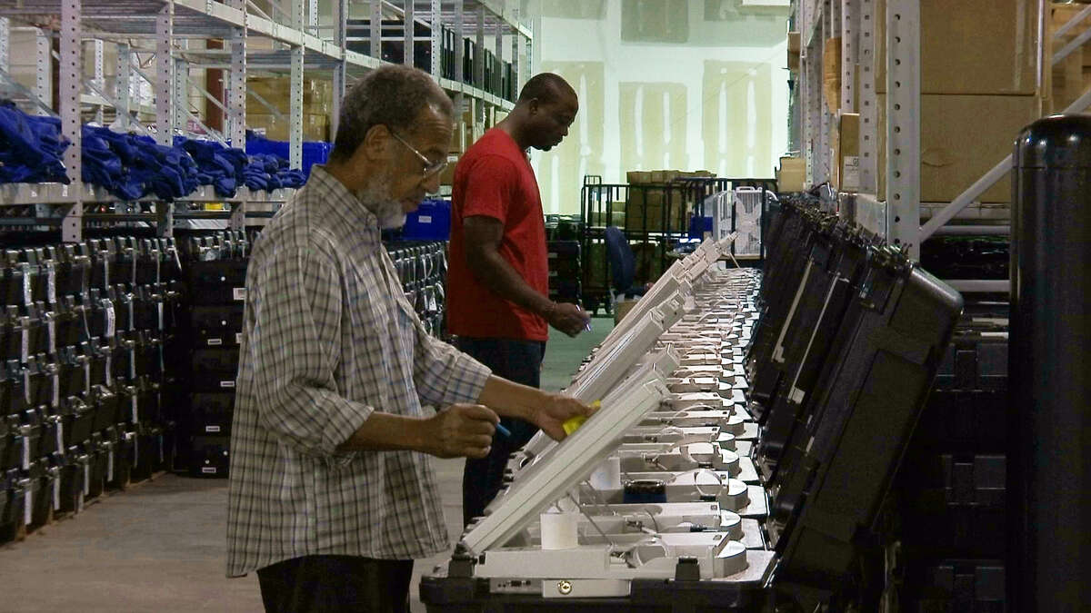 FILE - This Sept. 22, 2016 file photo shows employees of the Fulton County Election Preparation Center in Atlanta test electronic voting machines. A security researcher disclosed a gaping security hole at the outfit that manages Georgia's elections. The lapse, which left the stateÂ?’s 6.7 million voter records and other sensitive files exposed to hackers, was first reported Wednesday, June 14, 2017, by the news site Politico. (AP Photo/Alex Sanz)