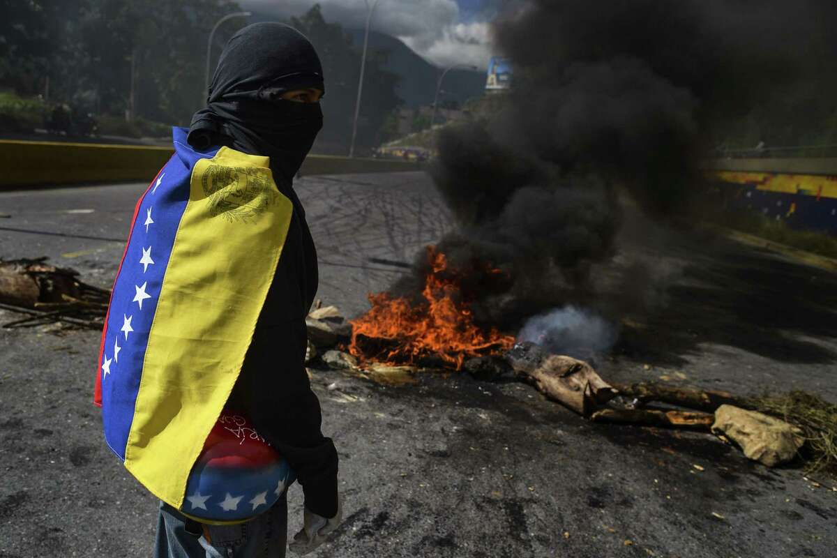 Anti-government demonstrators mount a roadblock during a protest against Venezuelan President Nicolas Maduro in Caracas, on June 14, 2017. With Venezuelans suffering from high inflation, food shortages and soaring crime rates, plus a deepening corruption scandal, the Venezuelan opposition has mounted near-daily anti-government protests since April 1. The protests have left 68 dead so far and more than a thousand injured, according to prosecutors. (Luis Robayo/AFP/Getty Images)