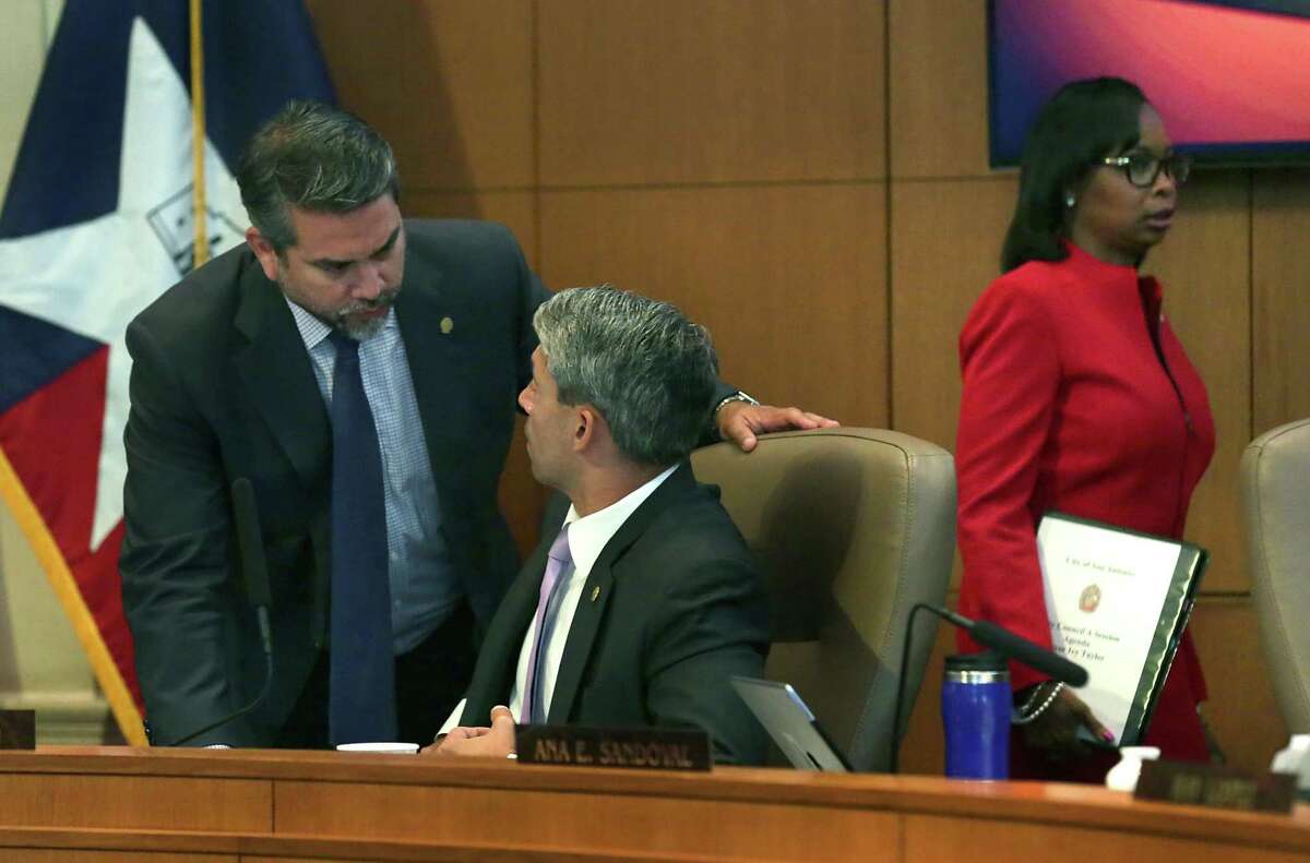 Councilman Roberto Trevino, left, speaks with Mayor elect Ron Nirenberg at the end of a city council meeting as Mayor Ivy Taylor walks out of her last council meeting as Mayor on Thursday, June 15, 2017.
