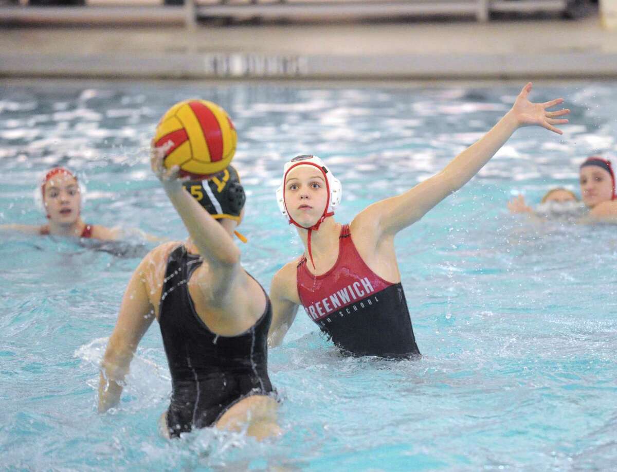 Kaila Carroll, right, of Greenwich, attempts to block the shot of Greenwich Academy’s Borden Wahl during the girls high school water polo match at the YMCA of Greenwich on April 4. Carroll was named to the USA Water Polo’s Cadet National Team.