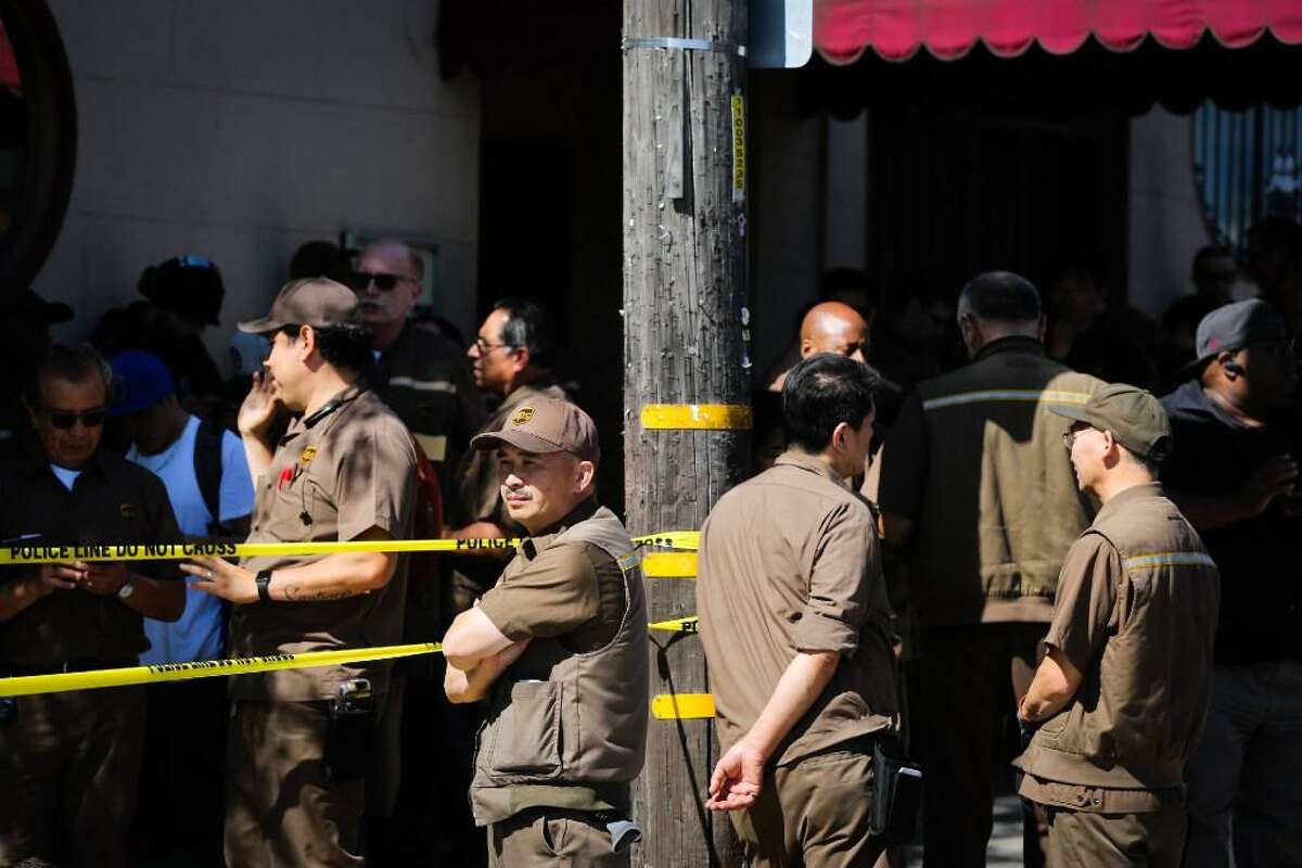 UPS workers who were evacuated from their building stand outside the scene of an active shooting on Utah Street and 16th Street in San Francisco, California, on Wednesday, June 14, 2017.