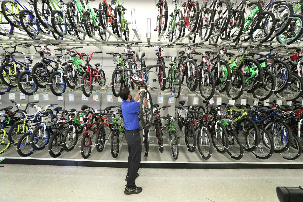 Academy Sports & Outdoors, 9734 Katy Freeway at Bunker Hill, Team Leader Dhiraz Hussain restocks bikes Thursday, June 1, 2017, in Houston. Academy Sports & Outdoors, a sports, outdoor and lifestyle retailer with more than 230 stores in 16 states, is one of Houston's largest private companies. ( Steve Gonzales / Houston Chronicle )