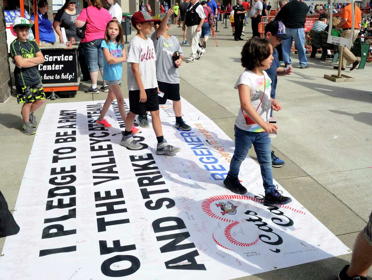 School children walk across a anti bullying banner as the Tri-City ValleyCats play the Albany Dutchmen on Education Day during an exhibition baseball game on Thursday, June 15, 2017, in Troy, N.Y. (Hans Pennink / Special to the Times Union) ORG XMIT: HP103