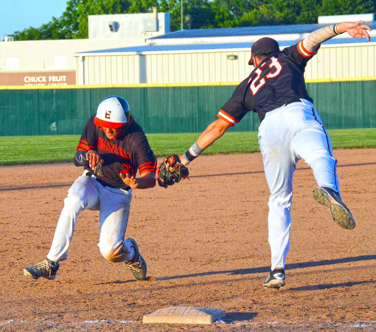 Edwardsville’s Chase Gockel, left, avoids the tag of Rawlings third baseman Stephen Randazzo in the fifth inning of Thursday’s game at Tom Pile Field.