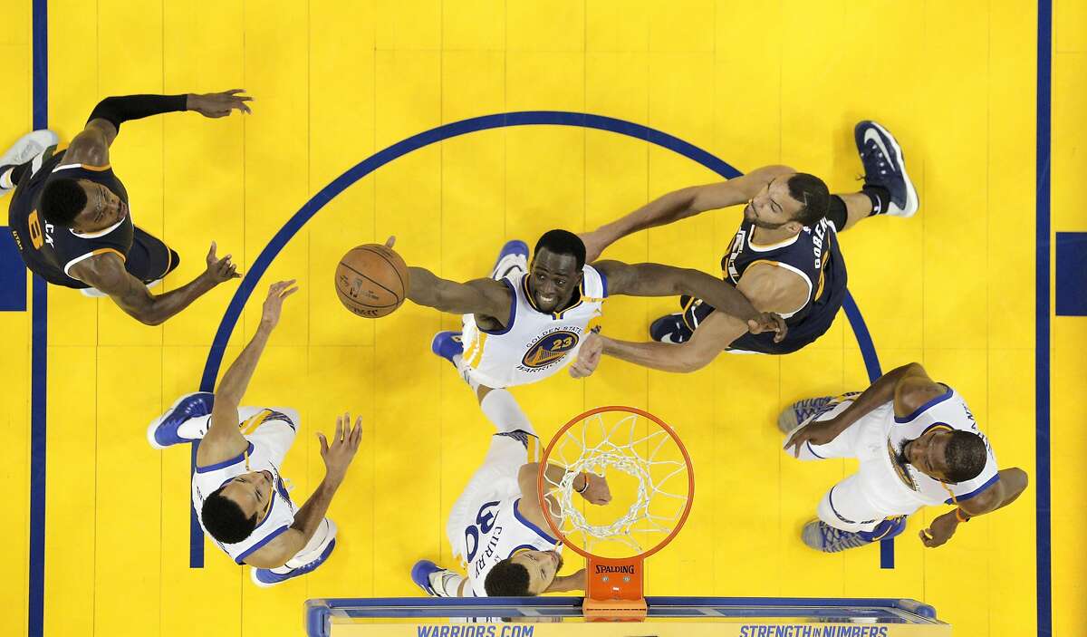 Draymond Green (23) reaches for a rebound on a shot by Rudy Gobert (27) in the second half as the Golden State Warriors played the Utah Jazz at Oracle Arena in Oakland, Calif., on Thursday, May 4, 2017, in Game 2 of the 2017 Western Conference Semifinals.