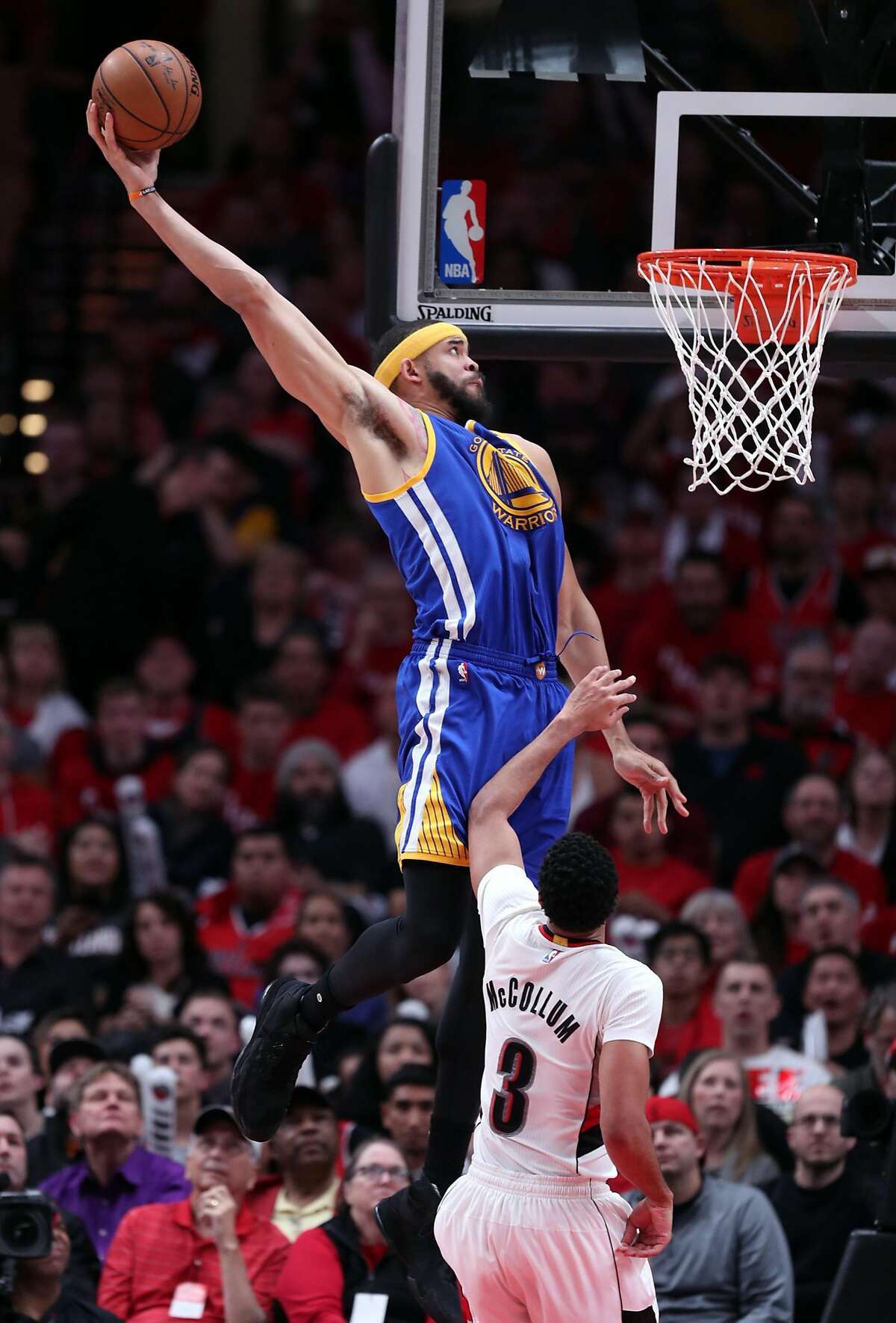Golden State Warriors' JaVale McGee dunks in 3rd quarter against Portland Trail Blazers' C.J. McCollum in Game 3 of NBA Western Conference 1st Round Playoffs at Moda Center in Portland, Oregon on Saturday, April 22, 2017.