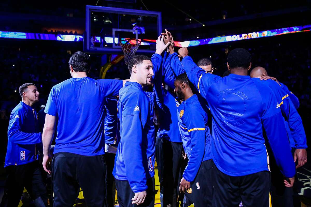 Golden State Warriors' Klay Thompson, #11 (center) cheers with his teammates ahead of a game against the Indiana Pacers, in Oakland, California, on Monday, Dec. 5, 2016.