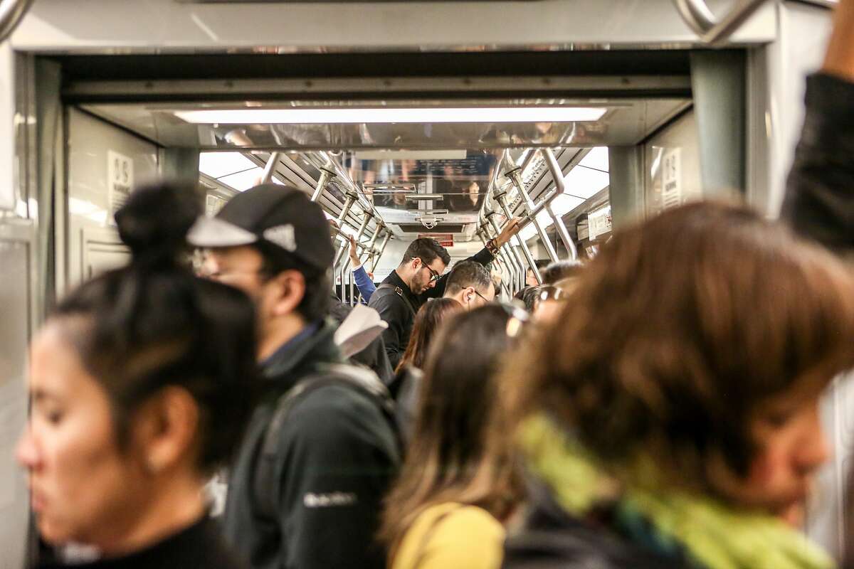 Riders are packed tightly on the N Judah Muni train during the morning commute on Thursday, June 15, 2017 in San Francisco, Calif.