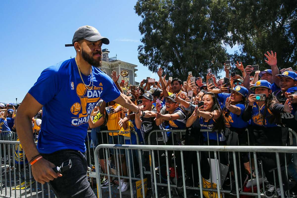 Golden State Warriors' JaVale McGee high-fives fans during the championship parade in Oakland, Calif., on Thursday, June 15, 2017.