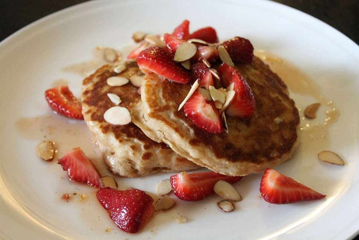 Whole-Wheat Buttermilk Pancakes from Celebrity Chef Curtis Stone. The real clincher is the scratch-made Strawberry-Maple Syrup! Topped with butter, spooned with fresh strawberries and sprinkled with almonds.