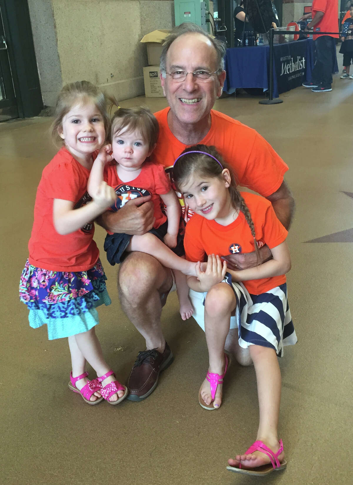 Ken Magidson surrounded, left to right, by  granddaughters, Selah, 5, Kate, 3, and Macy, 8, in September 2016 at Minute Maid Park. All three girls and their parents live in his home in northwest Houston.