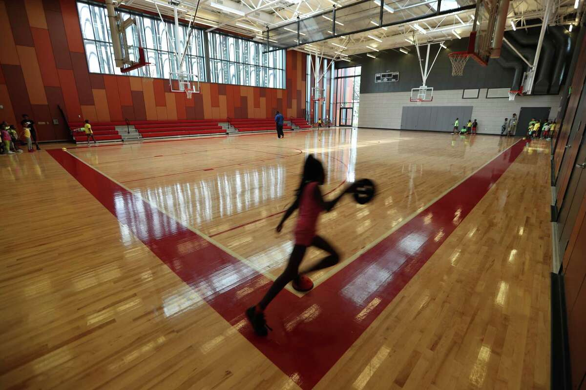 A girl plays inside the new Emancipation Park gym, part of a $34 million redevelopment project.
