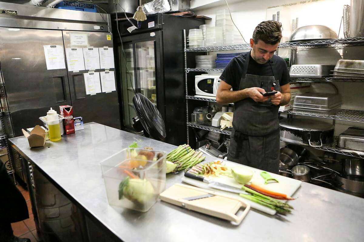 Chef Jonathan Sutton updates his BlueCart order as he preps produce at Per Diem restaurant on Friday, June 16, 2017 in San Francisco, Calif.