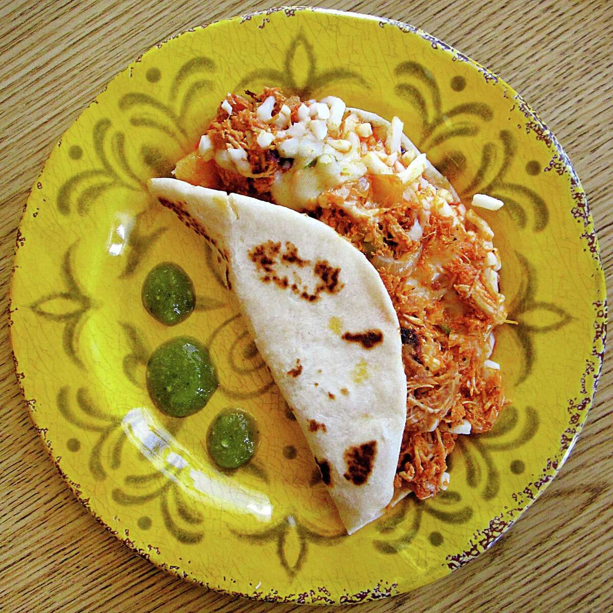 Chicken pirata taco with beans and queso blanco on a handmade flour tortilla from Santos Cafe #1.