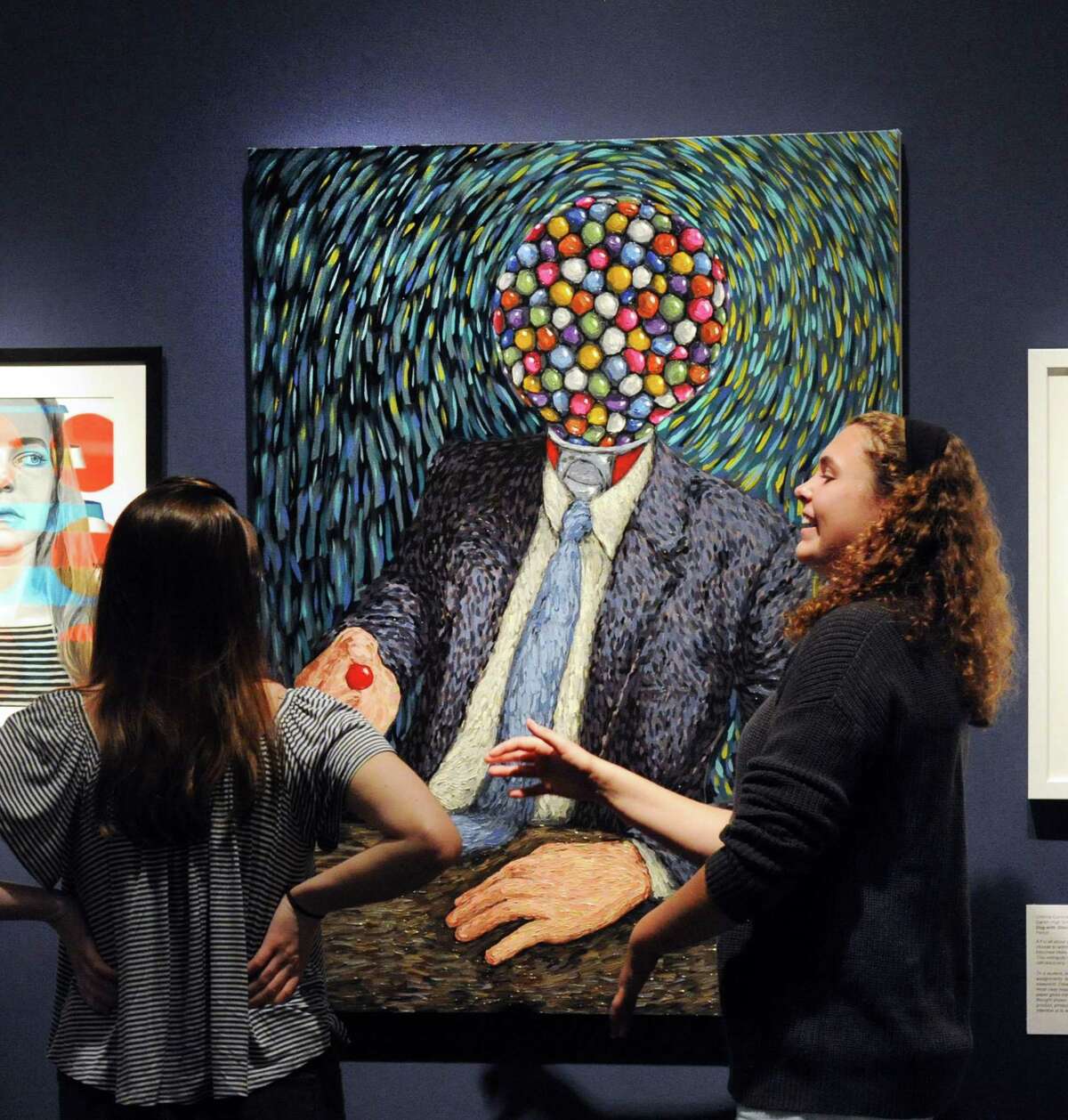 The third-place oil on canvas painting titled “Insider Trading,” by Will Carpenter, a Ridgefield High School senior, elicits a reaction out of Bruce Museum intern Megan Hobbs, right, a Darien High School senior, during the Bruce Museum’s new exhibition, iCreate, the annual juried art show featuring the work of high school students at the museum in Greenwich, Conn., Thursday, June 15, 2017. The exhibition runs until July 30th and features 42 artworks chosen out of over 700 entries received from high school students in the states of Connecticut and New York.