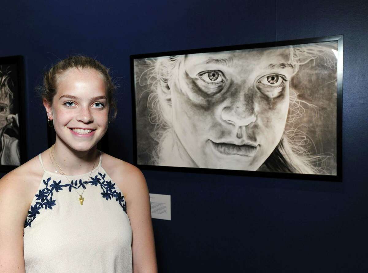 Darien High School senior Courtney Lowe, 18, took second place with her larger-than-life charcoal self-portrait titled "One More," that is part of the Bruce Museum's new exhibition, iCreate, the annual juried art show featuring the work of high school students at the museum in Greenwich, Conn., Thursday, June 15, 2017. The exhibition runs until July 30th and features 42 artworks chosen out of over 700 entries received from high school students in the states of Connecticut and New York.