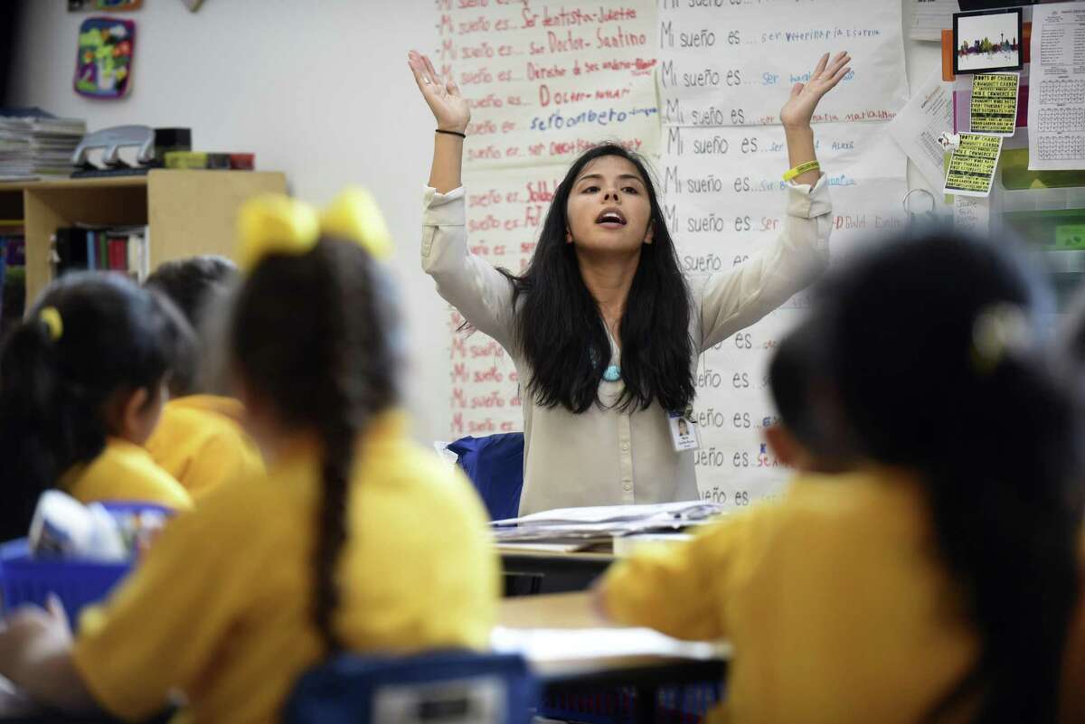 Maria Rocha, who teaches at KIPP Esperanza Dual Language Academy, works with students on Wednesday, Jan. 11, 2017. Rocha is an immigrant and has deferred action status.