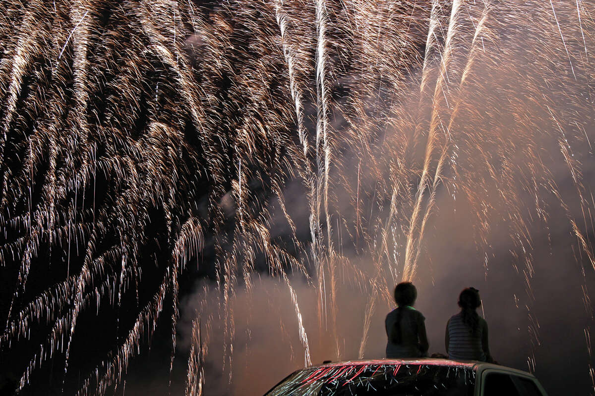 Children watch as fireworks explode over American Legion Post 199 during last year's celebration.