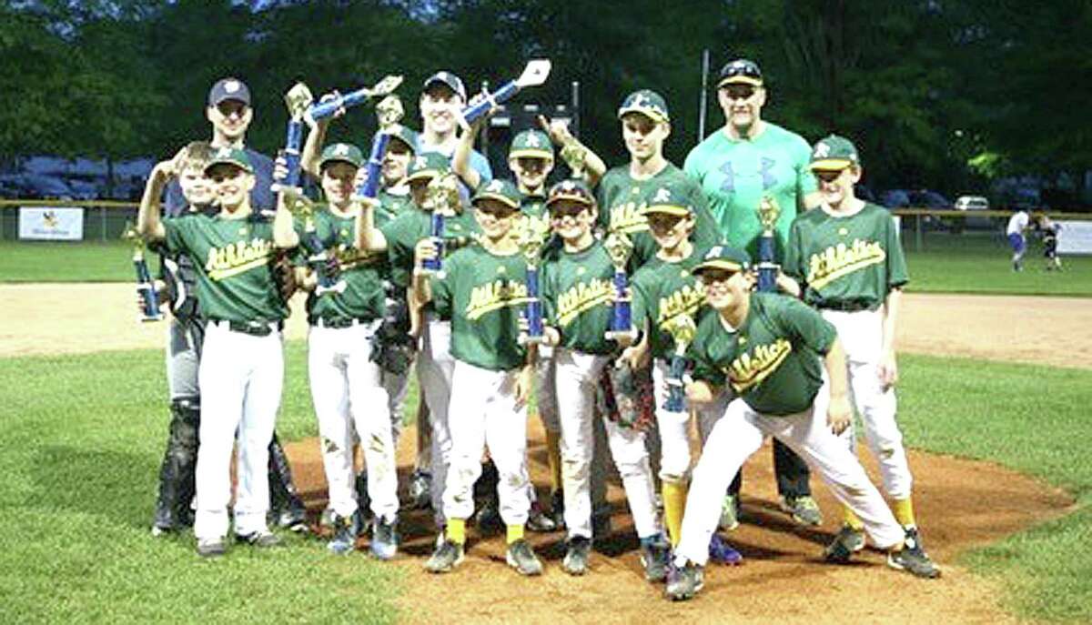 The Wilton Little League Athletic A’s Majors baseball team sponsored by Bankwell took home the championship against the Braves 10-8. Players include, from left, Chris McCann, George Hahn, Jonathan Yerrall, William McCormack, Jake Enman, Andrew Ryan, Ryan Preisano, James Ring, Ian Seelert, Zachary Krawitz, Max Scolnik, and James Doylem, and coaches Bob Ryan and Keith McCormack and Head Coach Anthony Preisano.