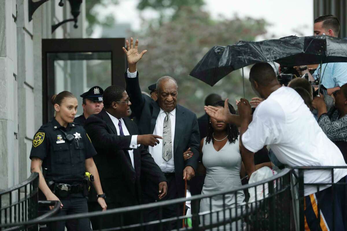Bill Cosby, center, gestures while exiting the Montgomery County Courthouse with his publicist Andrew Wyatt, second from left, after a mistrial was declared in his sexual assault trial in Norristown, Pa., Saturday, June 17, 2017. Cosby's trial ended without a verdict after jurors failed to reach a unanimous decision. (AP Photo/Matt Slocum)
