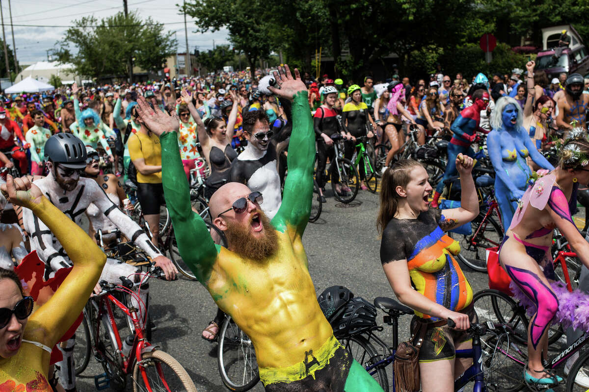 Naked cyclists in creative paint wait to ride before the Fremont Solstice Parade in Seattle on Saturday, June 17, 2017.