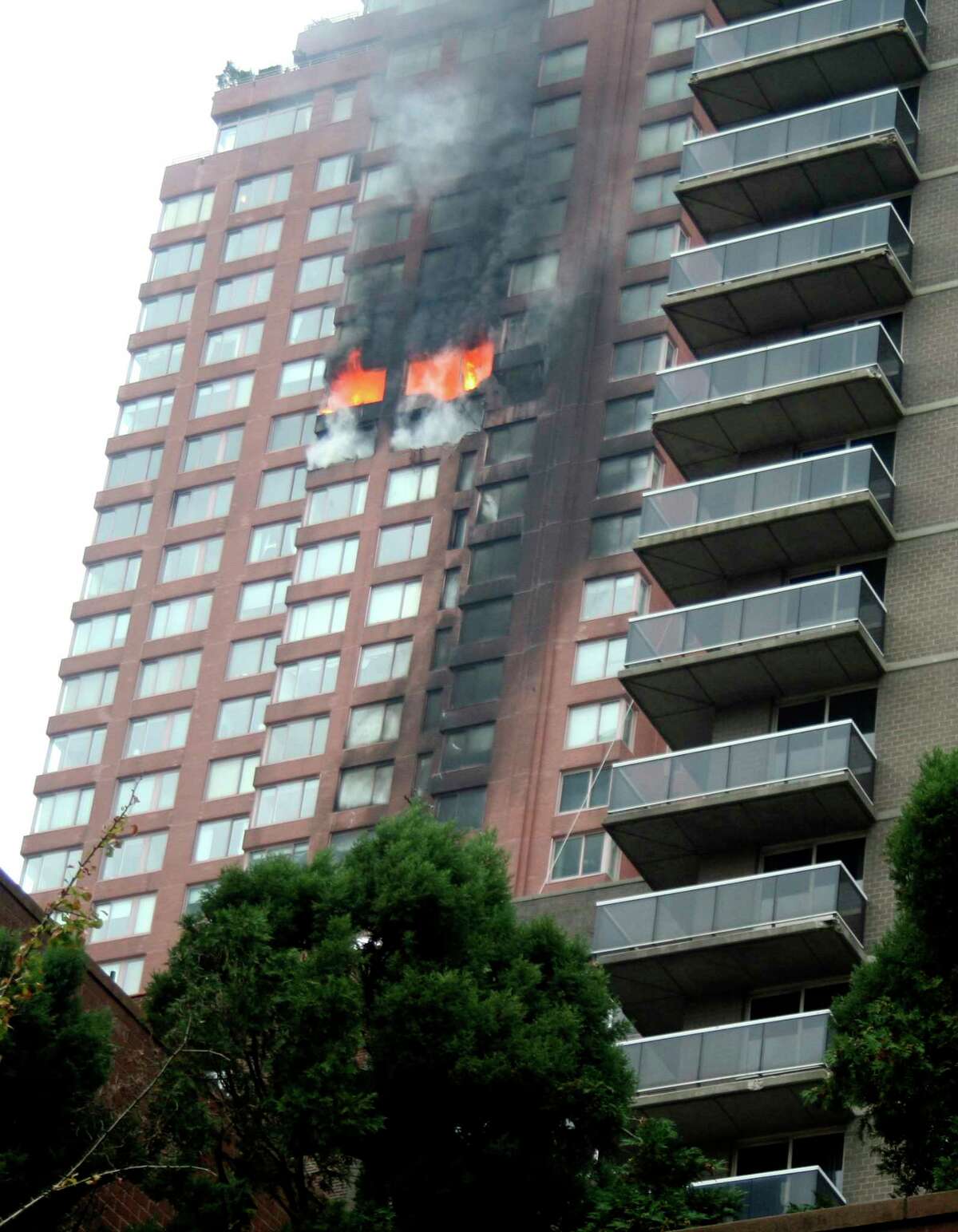 FILE- In this Oct. 11, 2006 file photo, a fire burns in the apartment where a small plane crashed into a 50-story residential building in New York. Fire safety experts recommend that you "stay put" If a fire breaks out elsewhere in the building. They say that it's best advice as long as the building has proper fire suppression protections, like a sprinkler system, fireproof doors and flame-resistant construction materials. (AP Photo/Larry LeVine, File) ORG XMIT: NYR403