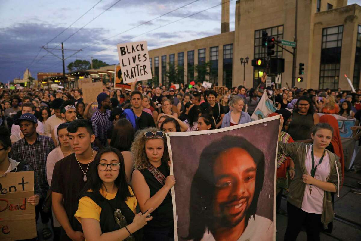 Supporters of Philando Castile hold a portrait of Castile as they march along University Avenue in St. Paul, Minn., leaving a vigil at the state Capitol on Friday, June 16, 2017. The vigil was held after St. Anthony police Officer Jeronimo Yanez was cleared of all charges in the fatal shooting last year of Castile. (Anthony Souffle/Star Tribune via AP) ORG XMIT: MNMIT345